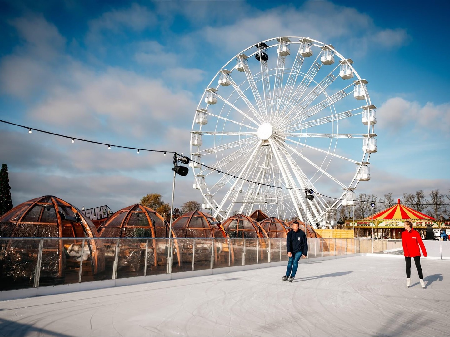 Two ice skaters enjoying the ice at the winter rink in Cambridge. 