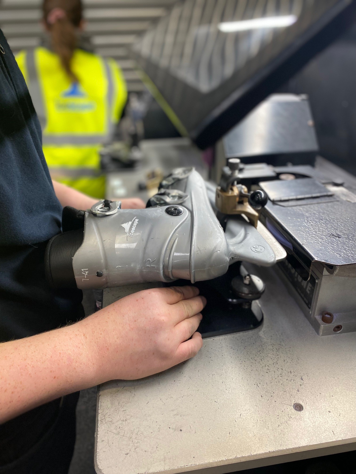 Icescape ice skates being sharpened on a machine.