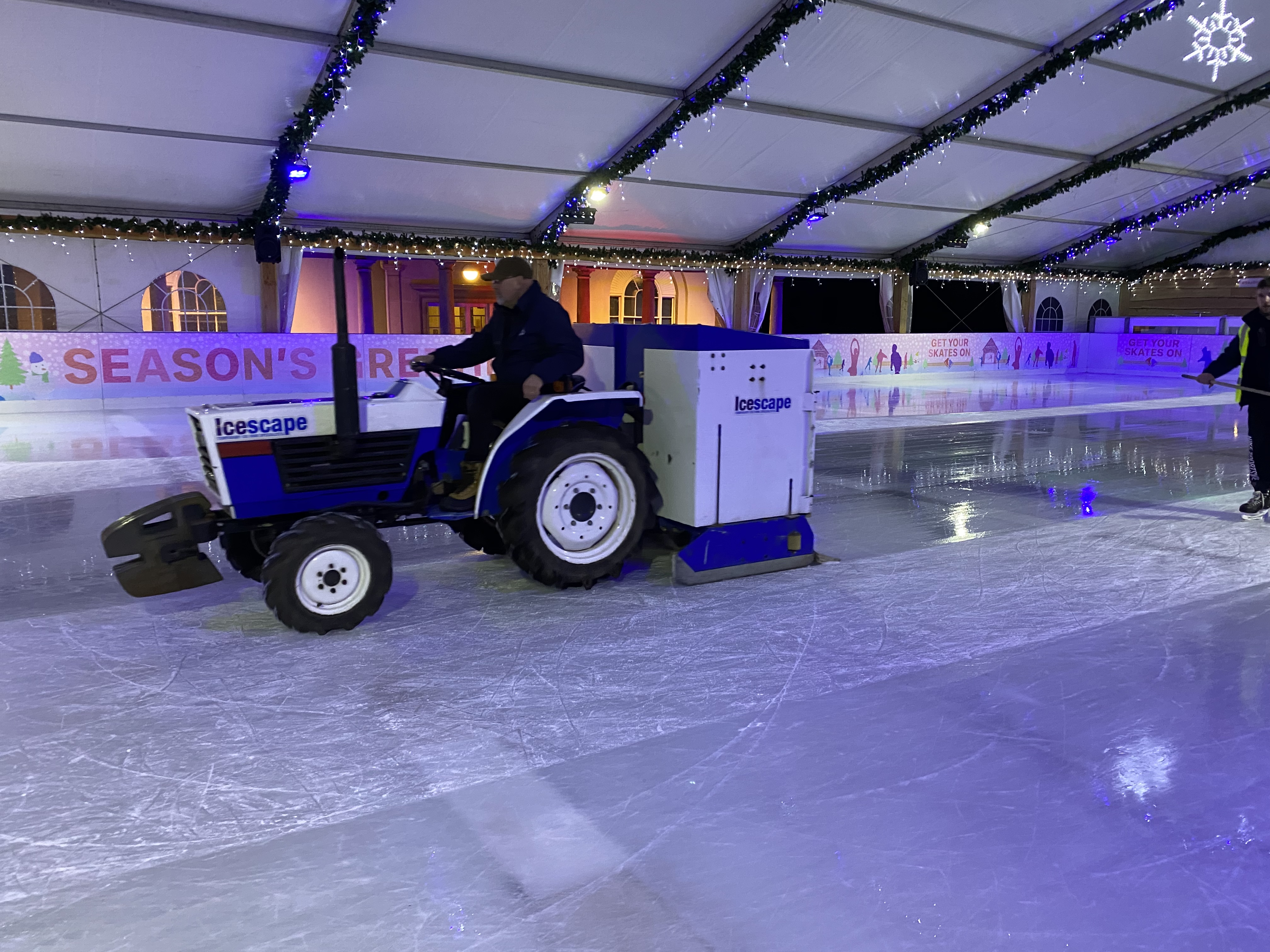 Tractor ice resurfacer maintaining the ice at a winter ice rink. 
